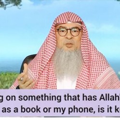 Laying on something that has Allah's name such as a book or my phone, is it kufr?